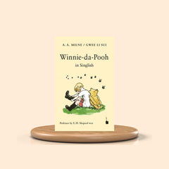 Book titled 'Winnie-da-Pooh' by A. A. Milne on a beige background