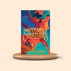 Book titled 'Impossible Creatures' by Katherine Rundell on a beige background