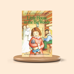 Book titled 'Little House in the Big Woods' by Laura Ingalls Wilder on a beige background