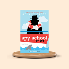 Book cover of 'Spy School at Sea' by Stuart Gibbs on a beige background